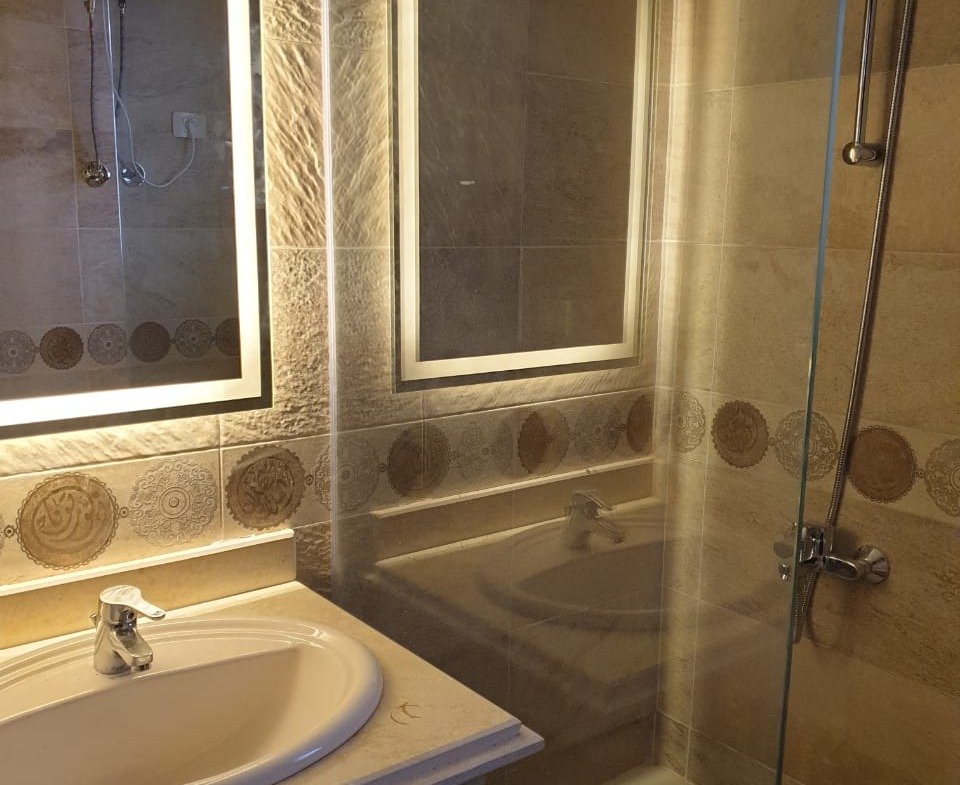 Bathroom with illuminated mirror and shower - villa in Telal, Ain Sokhna