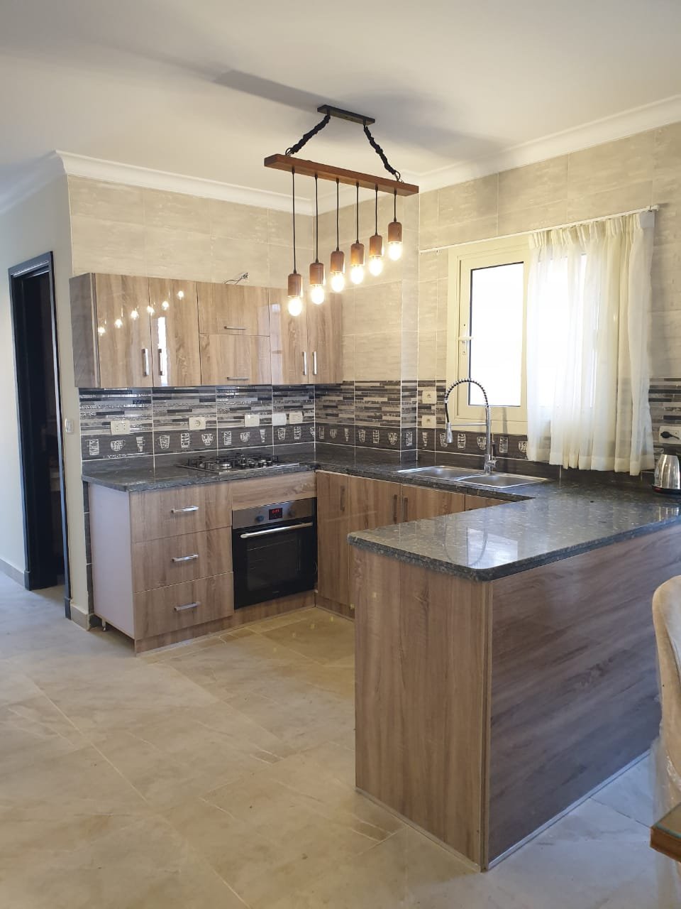 villa-for-rent-telal-ain-sokhna-160-sqm-kitchen Open kitchen with wooden cabinets - villa in Telal, Ain Sokhna