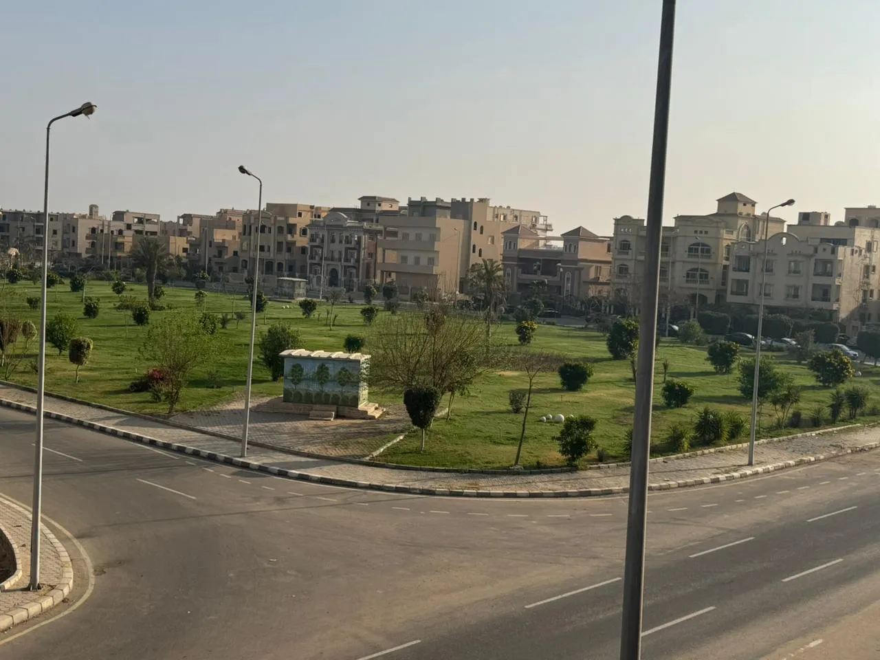 Street and green park seen from the apartment - apartment in El Yasmeen 4, New Cairo