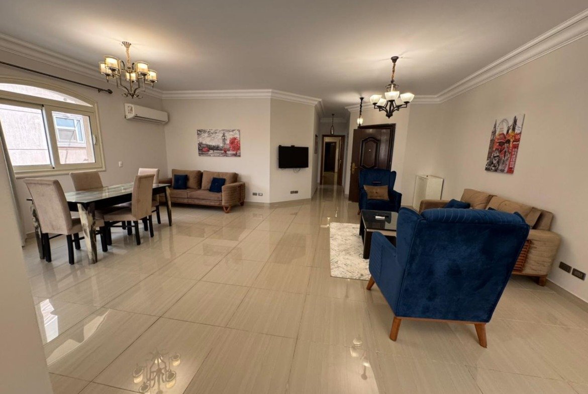 Furnished reception with blue sofas and chandeliers - apartment in El Yasmeen 4, New Cairo