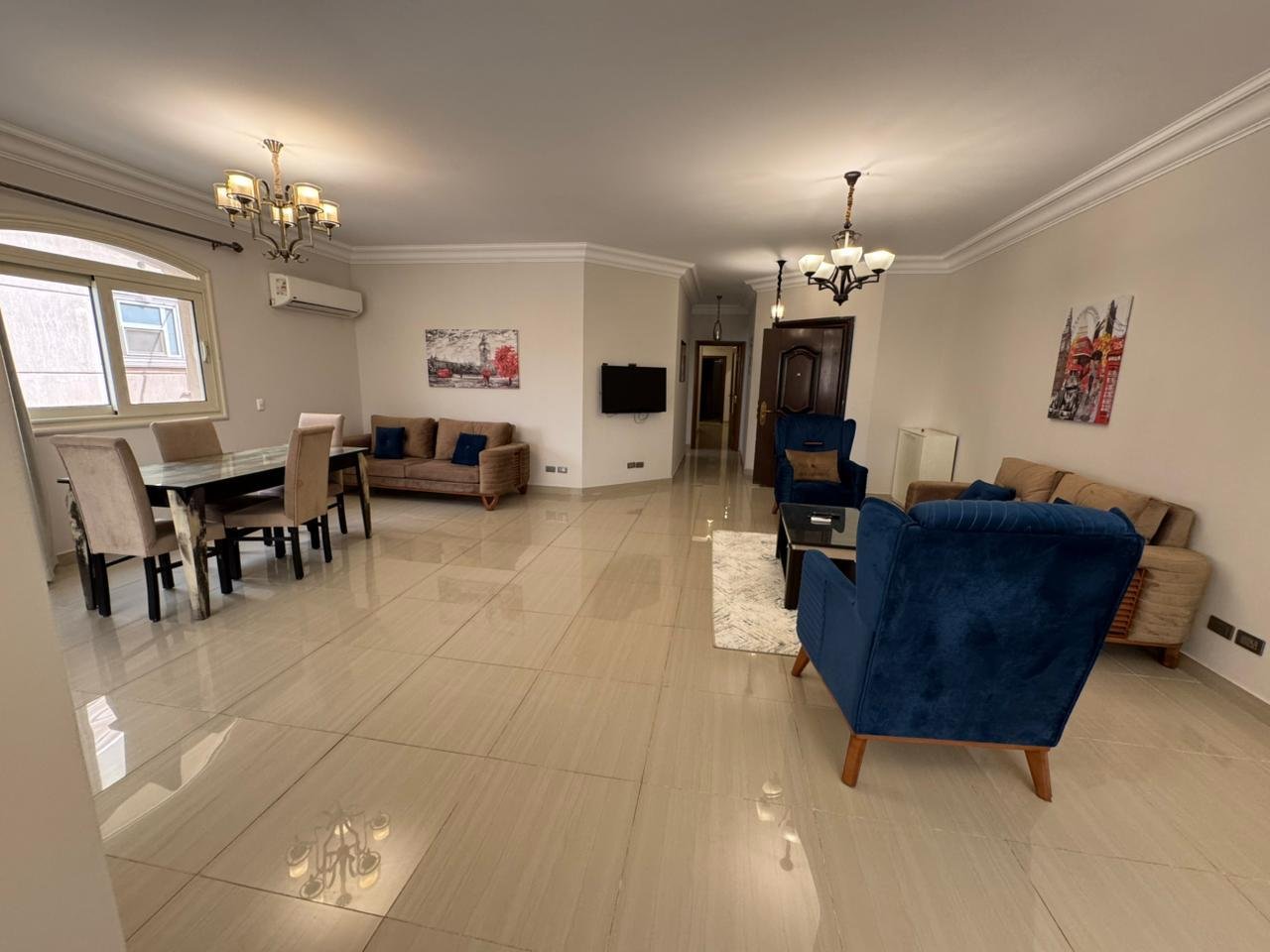 Furnished reception with blue sofas and chandeliers - apartment in El Yasmeen 4, New Cairo