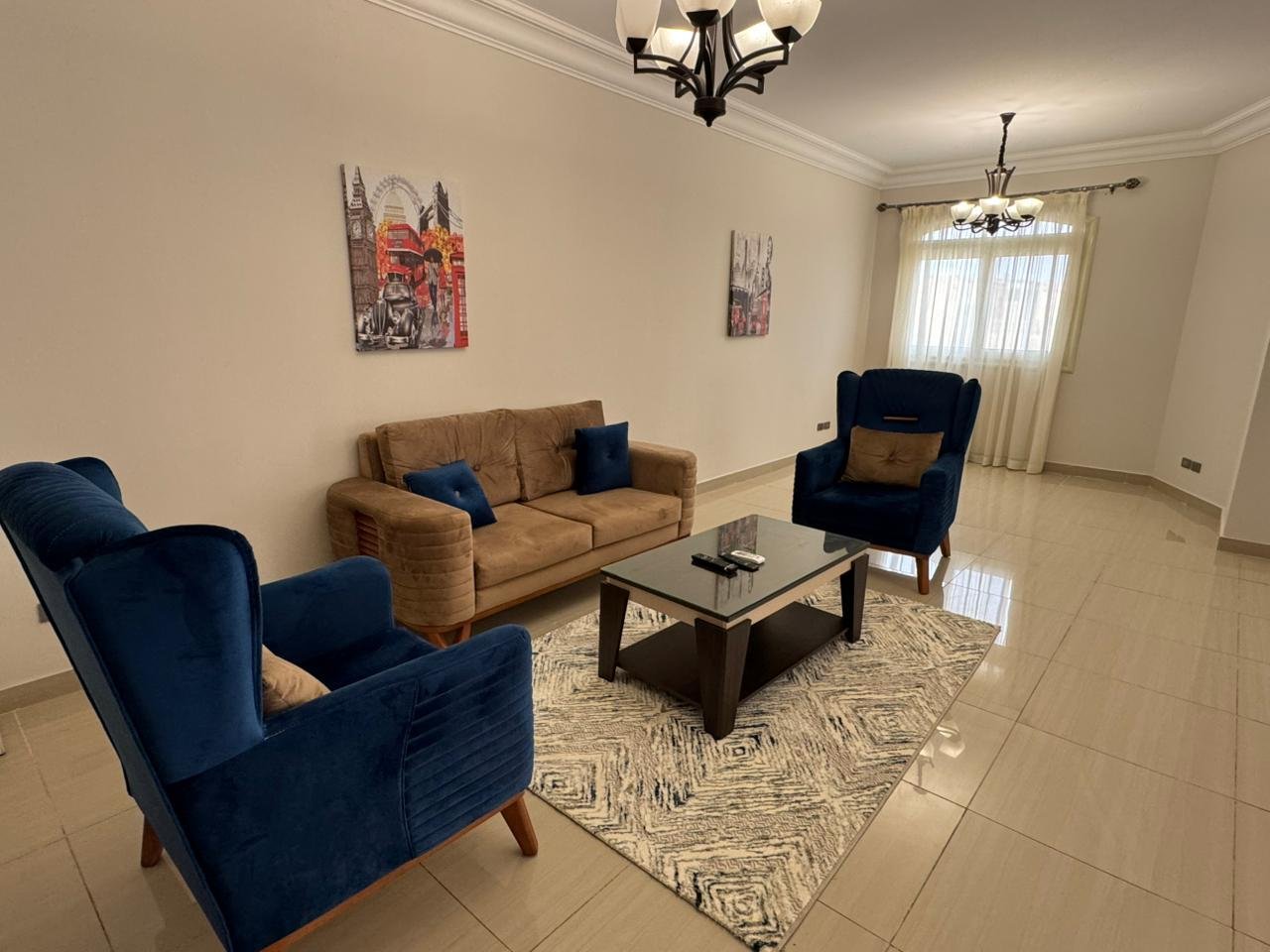 Living area with two blue armchairs and a tan sofa - apartment in El Yasmeen 4, New Cairo