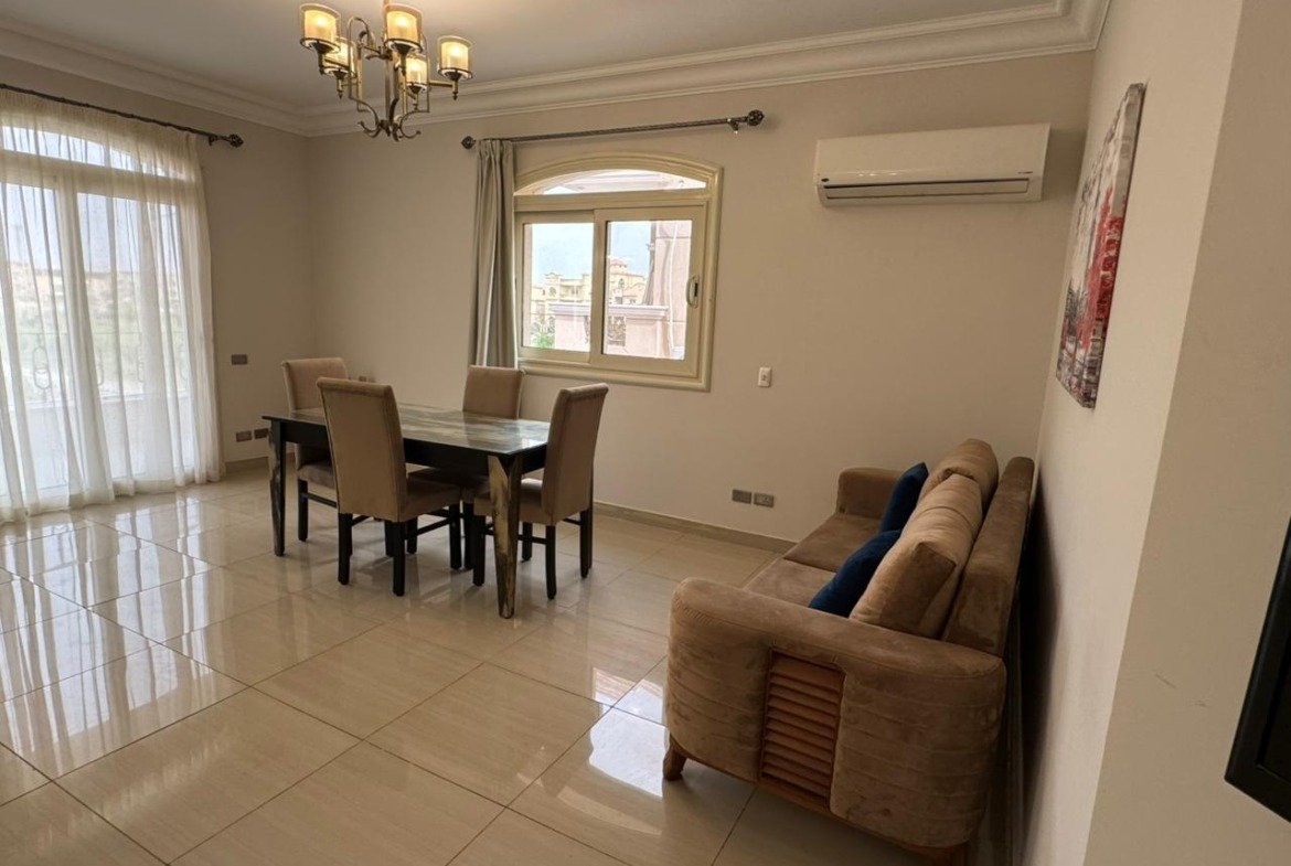 Dining table beside a sofa in a bright reception - apartment in El Yasmeen 4, New Cairo
