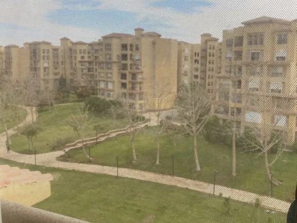 Green compound view from apartment in Zone T, Taj City - فيو المساحات الخضراء من شقة في زون تي تاج سيتي - apartment for sale in Zone T Taj City